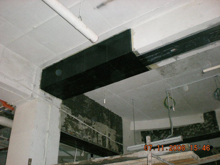 Carbon fibre fabric and carbon plate bonded to a concrete beam