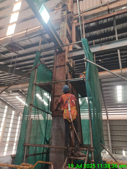 Worker on scaffolding reinstating a damaged column