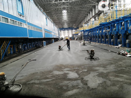 Floor hardener being power-floated inside a paper mill