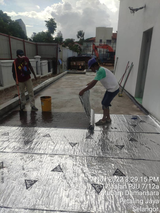 Self-adhesive waterproofing membrane being laid